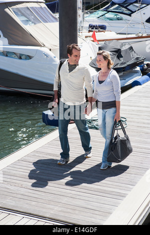 Caucasian couple walking on dock Stock Photo