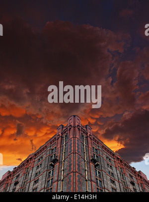 Dramatic Mammatus storm clouds over abandoned, derelict building Stock Photo