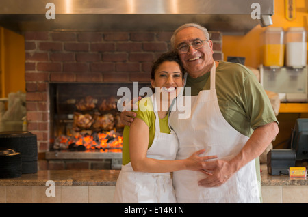 Hispanic father and daughter working in restaurant Stock Photo