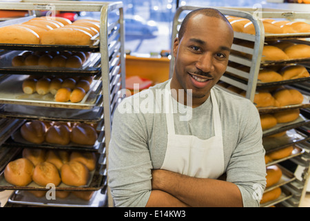 Black baker working in commercial kitchen Stock Photo