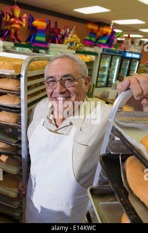 Hispanic baker working in commercial kitchen Stock Photo
