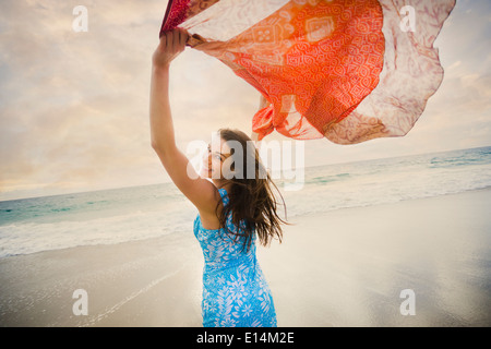 Caucasian woman playing on beach Stock Photo