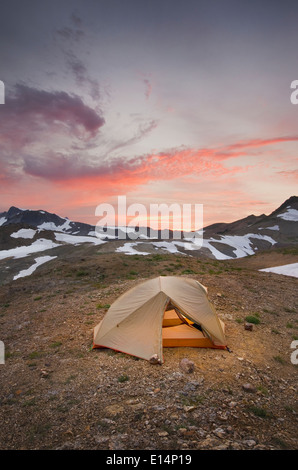 Tent at campsite in snowy mountain landscape Stock Photo