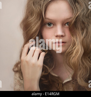 Caucasian girl playing with her hair Stock Photo