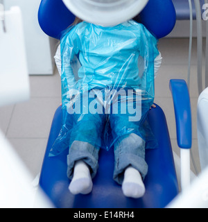 Caucasian girl wearing plastic sheet at dentist Stock Photo