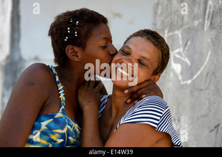 Former street child, girl, 15, hugging her mother, Lapa district, Rio de Janeiro, Rio de Janeiro State, Brazil Stock Photo
