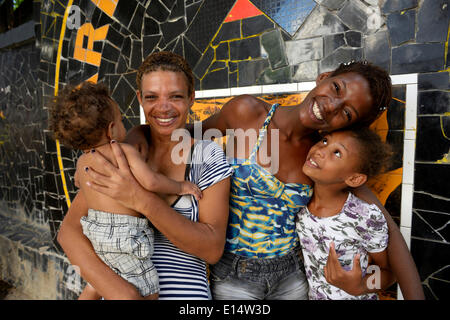 Former street child, girl, 15, hugging her mother and siblings, Lapa district, Rio de Janeiro, Rio de Janeiro State, Brazil Stock Photo