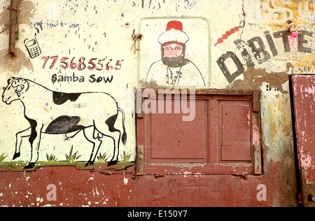 SAINT LOUIS DU SENEGAL, SENEGAL-APRIL 19, 2014: The butchers announce their business with colorful signs in the street on April Stock Photo