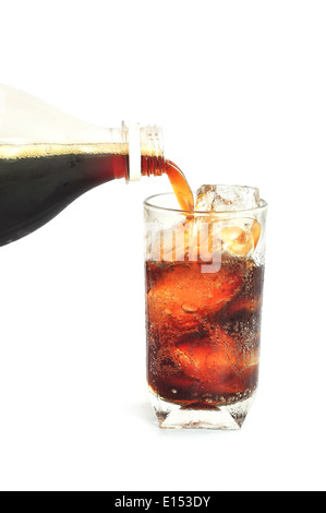 Pouring cola drink from a bottle into glass on white background Stock Photo