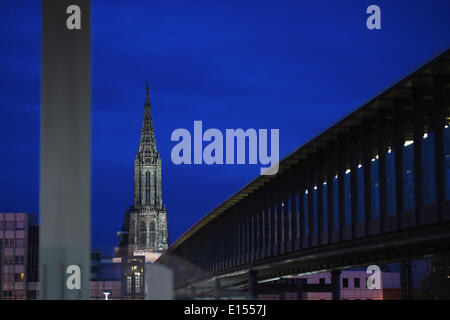 Ulm, Germany. 17th May, 2014. The minster at sunset in Ulm, Germany, 17 May 2014. The Ulm Minster has the world's tallest church steeple. It is a permanent construction site due to non-stop restoration work. The railway bridge is pictured in the foreground. Photo: Felix Kaestle/dpa/Alamy Live News Stock Photo