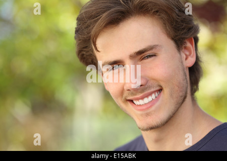 Handsome man face with a white perfect smile with a green background Stock Photo