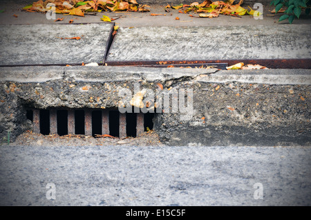 Sidewalk with a street drainage Stock Photo