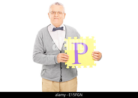 Mature man holding a piece of puzzle with the letter p on it Stock Photo