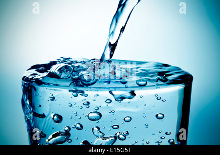 a refreshing glass of water which is being filled Stock Photo - Alamy