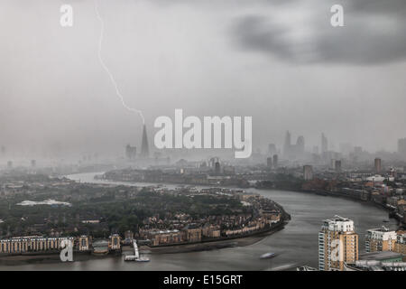 London, UK. 22nd May, 2014. Seen from the Canary Wharf financial district, a bolt of lightning strikes The Shard as a thunderstorm passes through the capital. At 310m tall, The Shard is western Europe's tallest building. Credit:  Steve Bright/Alamy Live News Stock Photo