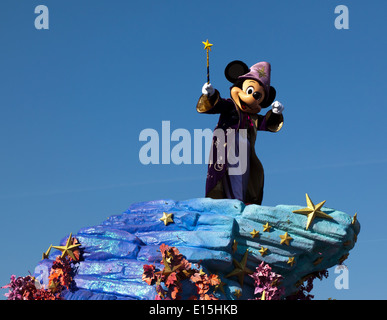 A Disney Parade with Micky Mouse dressed as  'The Sorcerer's Apprentice' from the Disney film Fantasia. Stock Photo