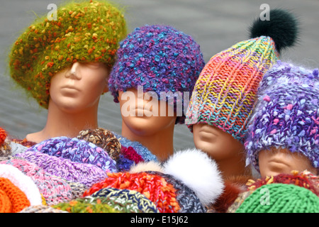 Colorful hand knitted hats on street sale Stock Photo