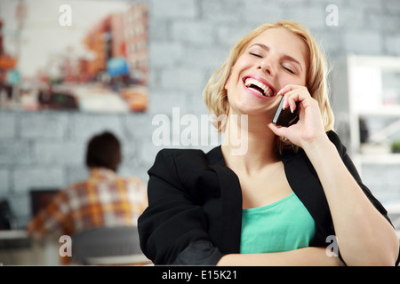 Laughing young woman talking on the office in office Stock Photo