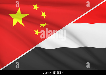 Flags of China and Republic of Yemen blowing in the wind. Part of a series. Stock Photo