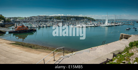 Panorama of yacht marina in Brixham Devon England with yachts and lifeboat moored at pier. Stock Photo