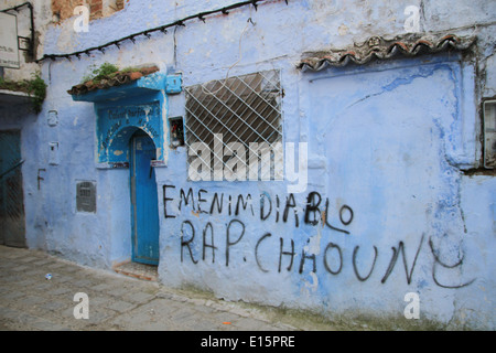 Blue painted street with graffiti in Chefchaouen, Morocco Stock Photo