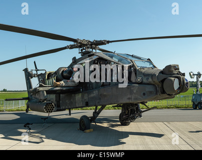 AH-64D Apache attack helicopter on display. Soldier resting in the shadow. Digital mid format shot. Stock Photo