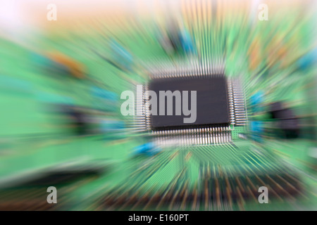 Printed Circuit board from a computer in green with focus on the micro chip. Stock Photo