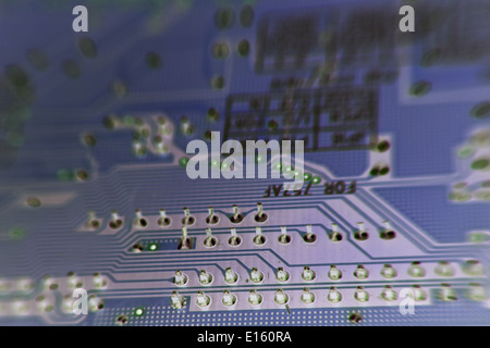 Printed Circuit board from a computer in a dark blue/purple. Stock Photo