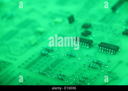 Printed Circuit board in green with focus of through-hole resistor. Stock Photo
