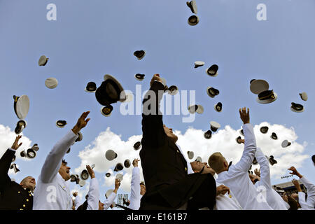 US Naval Academy Graduating midshipmen toss their hats into the air celebrating the end of commencement and their graduation May 23, 2014 in Annapolis, Maryland. Stock Photo
