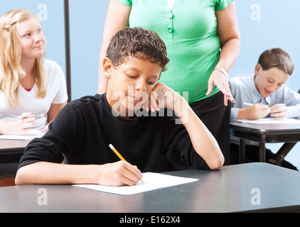 Student struggling with a standardized test in school.  Stock Photo