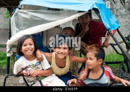 children in pedicab, village, Butuan, Philippines Stock Photo