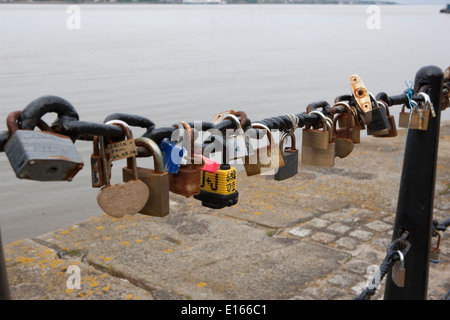 Thousands of padlocks on railing beside the River Mersey in Liverpool beside the Albert Dock, left by lovers, Stock Photo