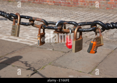 Some of the thousands of padlocks on railing beside the River Mersey in Liverpool beside the Albert Dock, left by lovers. Stock Photo
