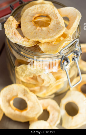 dried Apple Rings in a Jar on wooden Table Stock Photo