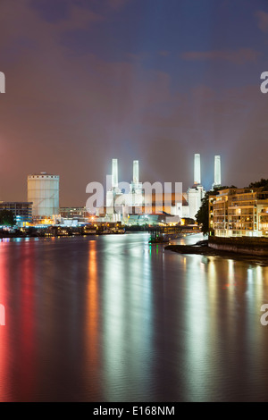 Battersea Power Station in London at night with the Thames River in the foreground Stock Photo