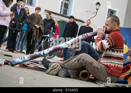 A street entertainer playing the didgeridoo in the square called Kapitelplatz in the city of Salzburg Austria Europe EU 2013 Stock Photo