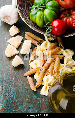 Fresh green and red tomatoes with mixed pasta Stock Photo