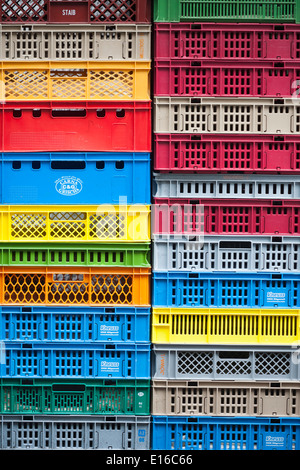 Stack of colorful plastic transport boxes stacked in front of a store in Zurich, Switzerland. Stock Photo