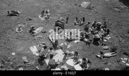 People hippies kids children group relaxing talking socialising sunbathing at Laurieston Hall  in summer 1970s hippie commune in Scotland UK Great Britain.  KATHY DEWITT Stock Photo