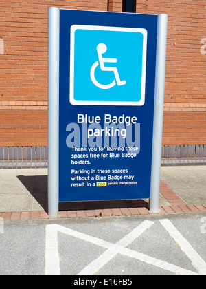 Closeup of Blue Badge wheelchair symbol and disabled parking signage in ...