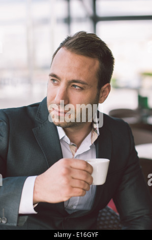 Serious man drinking espresso in caffe Stock Photo