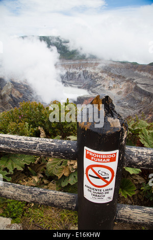 Ironic Smoking Prohibited sign next to the smoking volcanic vent of Poas volcano in central Costa Rica Stock Photo