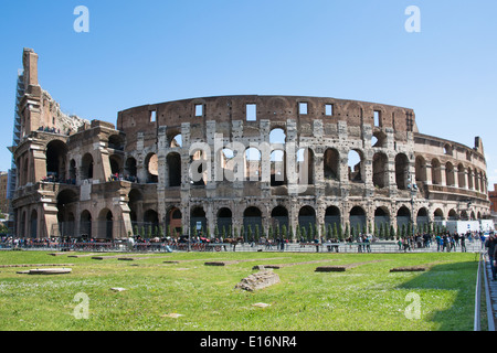 rome,italy-April 17,2014:tourists admire the coliseum in the centre of ancient rome in a sunny day Stock Photo