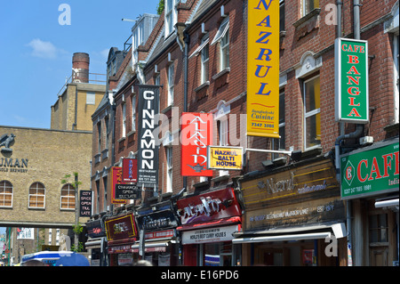 Several Asian restaurant sings along the famous Brick Lane in London, England, United Kingdom. Stock Photo