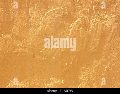 Yellow cement wall abstract background plaster construction. Stock Photo