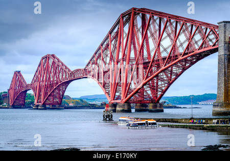 Small ferries take passengers out to a cruise ship anchored in the Firth of Forth at South Quensferry, Scotland Stock Photo