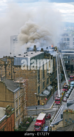 Glasgow School of Art's Mackintosh building in Glasgow Scotland on fire with fire fighters fighting the flames inside & outside. Stock Photo