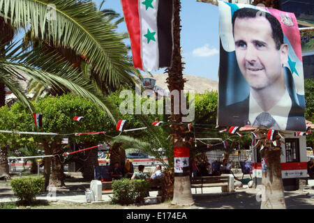 Damascus. 25th May, 2014. People walk under posters of Syria's presidential elections in Damascus, on May 25, 2014. Electoral campaigns in Syria started on May 11 and would end 24 hours ahead of the voting. Credit:  Bassem Tellawi/Xinhua/Alamy Live News Stock Photo