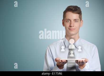 Businessman holding computer tablet with social media people icons in hands Stock Photo
